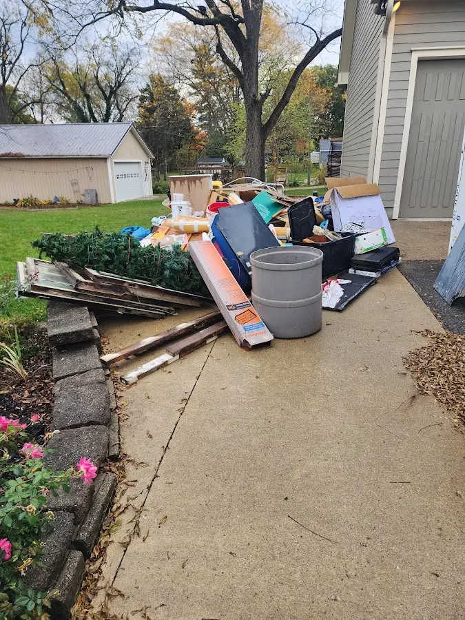 Dumpster being loaded with debris for Estate Cleanout Dumpster Rental in Statesboro